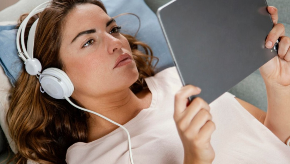 Woman with headphones using tablet

